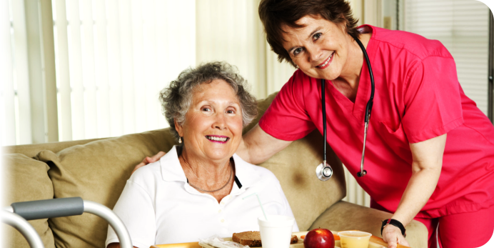 caregiver and the elder woman smiling